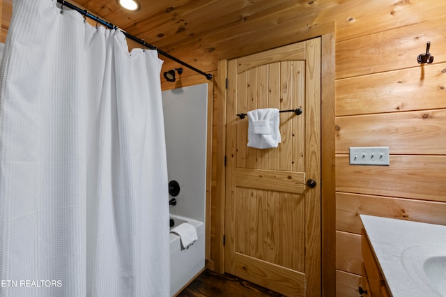 bathroom featuring vanity, wooden walls, and wooden ceiling