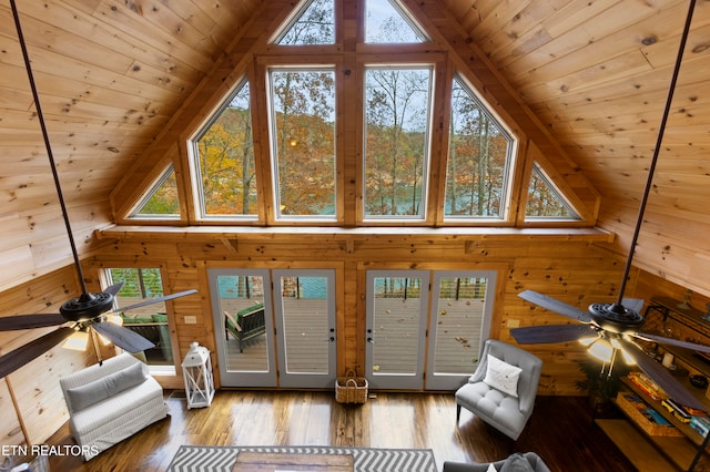 living room with plenty of natural light, wooden ceiling, wood-type flooring, and wood walls