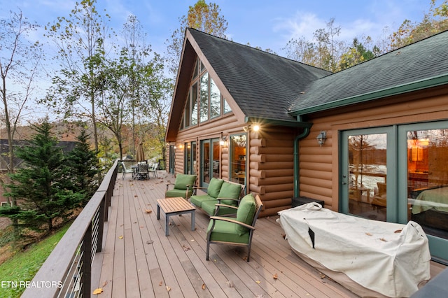 wooden deck with an outdoor living space