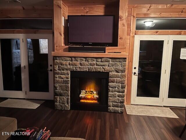 living area featuring wood finished floors and a stone fireplace
