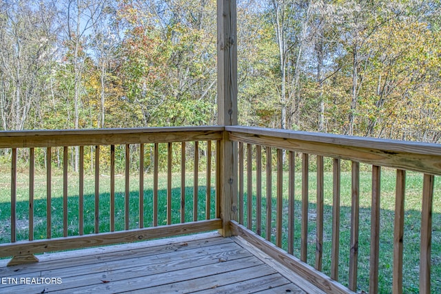 wooden terrace with a yard