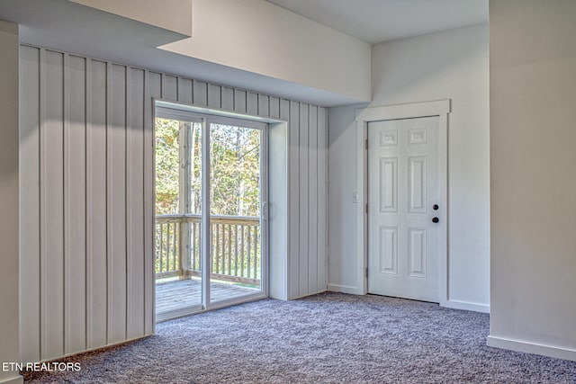 doorway to outside featuring carpet flooring