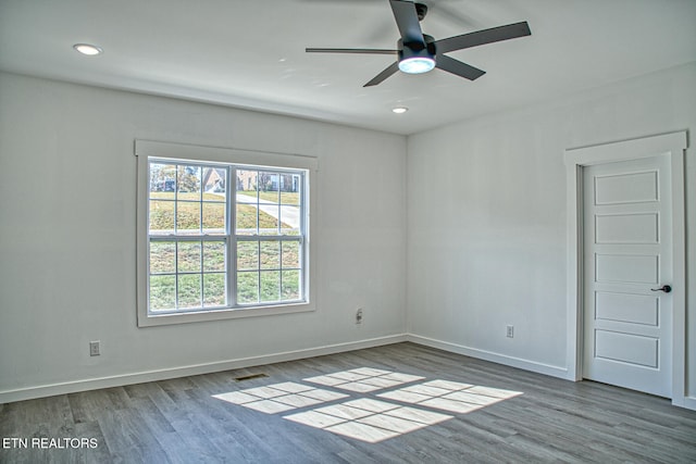 spare room featuring hardwood / wood-style flooring and ceiling fan