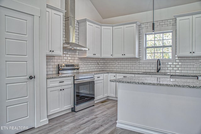 kitchen with white cabinets, sink, light hardwood / wood-style flooring, and electric stove