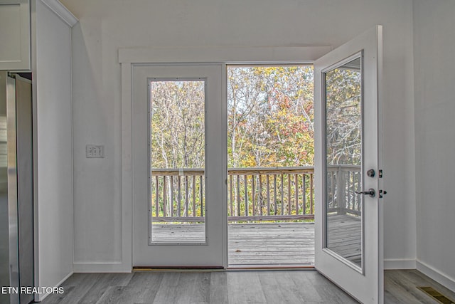 doorway to outside with light wood-type flooring and plenty of natural light