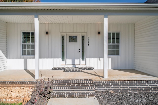 property entrance with covered porch