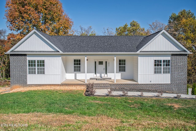 ranch-style home with a porch and a front lawn