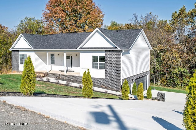 single story home featuring covered porch and a garage