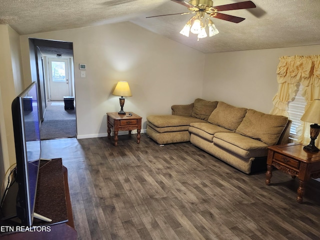 living room with a textured ceiling, ceiling fan, dark hardwood / wood-style flooring, and lofted ceiling