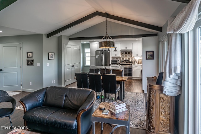 living room with vaulted ceiling with beams and dark hardwood / wood-style floors