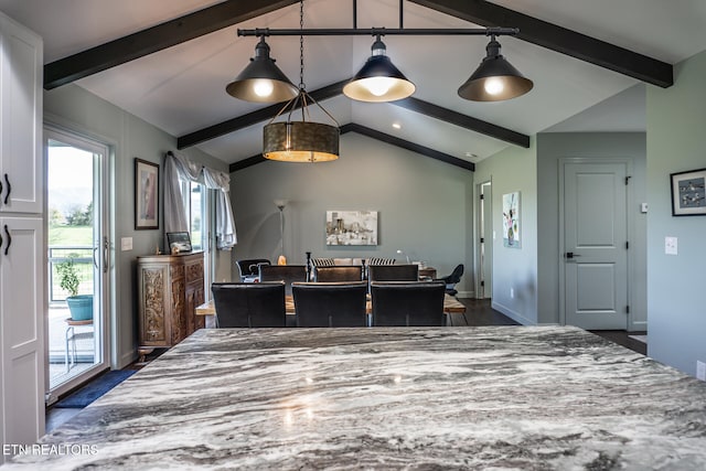 dining space featuring lofted ceiling with beams and dark hardwood / wood-style flooring