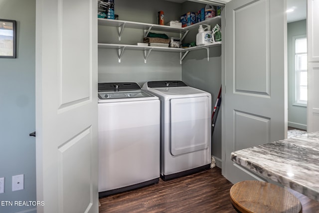 laundry area featuring washing machine and dryer and dark hardwood / wood-style flooring