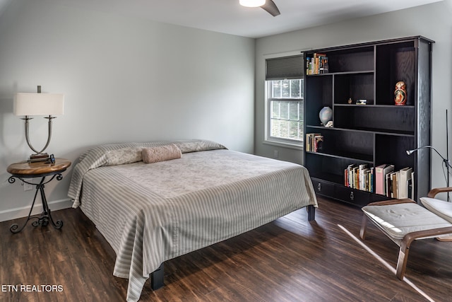 bedroom with ceiling fan and dark wood-type flooring