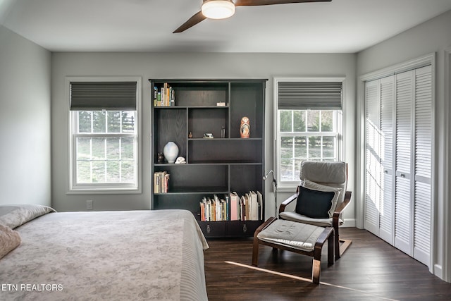 bedroom with dark hardwood / wood-style floors, ceiling fan, and a closet