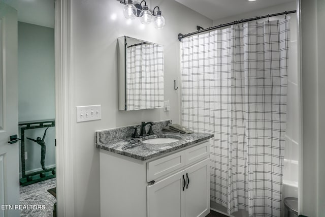 bathroom featuring vanity and shower / bath combination with curtain