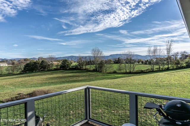 view of yard with a mountain view and a balcony