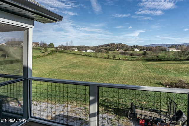 view of yard with a mountain view and a rural view