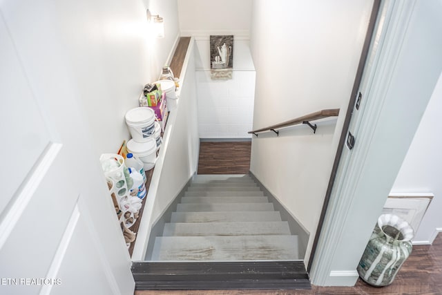 stairway with hardwood / wood-style floors