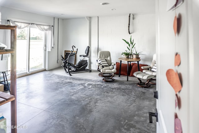 exercise room featuring concrete floors