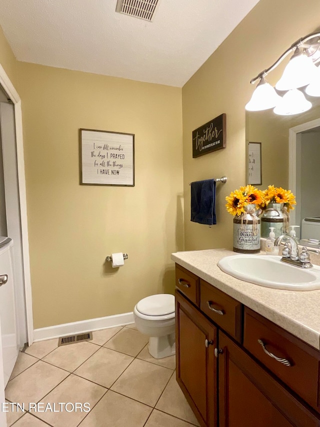 bathroom with visible vents, baseboards, toilet, tile patterned floors, and vanity