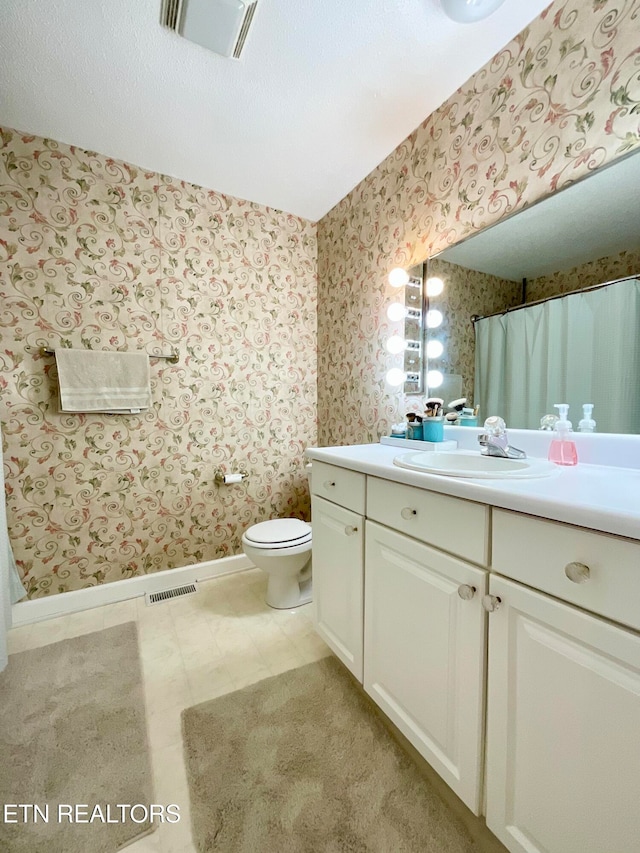 full bathroom with wallpapered walls, vanity, baseboards, and visible vents