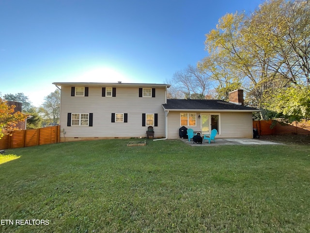 rear view of property featuring crawl space, a patio, a lawn, and fence