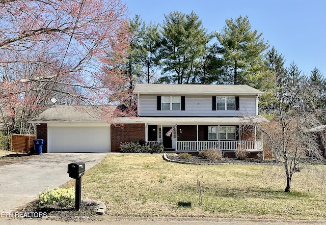 traditional-style house featuring covered porch, concrete driveway, a front yard, a garage, and brick siding