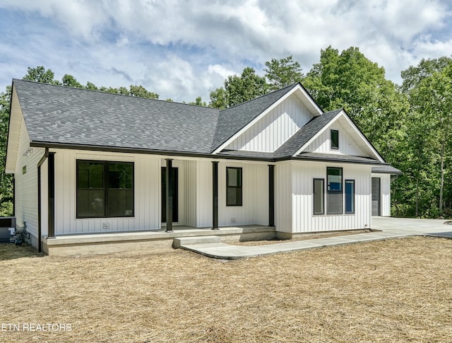 back of property featuring covered porch