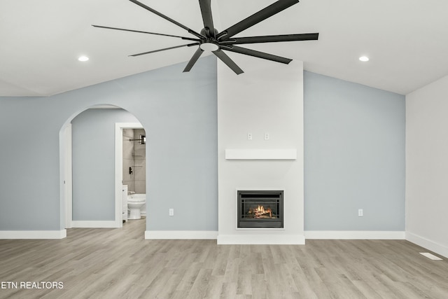 unfurnished living room with ceiling fan, light wood-type flooring, and lofted ceiling