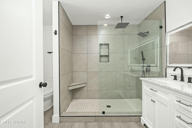 bathroom featuring hardwood / wood-style floors, vanity, and a textured ceiling