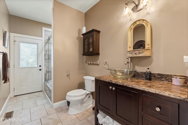 bathroom with tile patterned flooring, vanity, and toilet