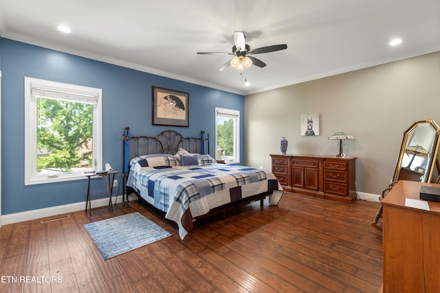 bedroom featuring ceiling fan, dark wood-type flooring, and ornamental molding