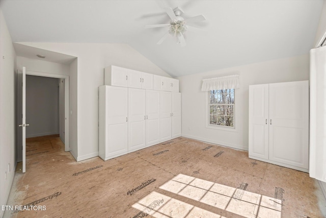 unfurnished bedroom featuring a closet, baseboards, vaulted ceiling, and a ceiling fan