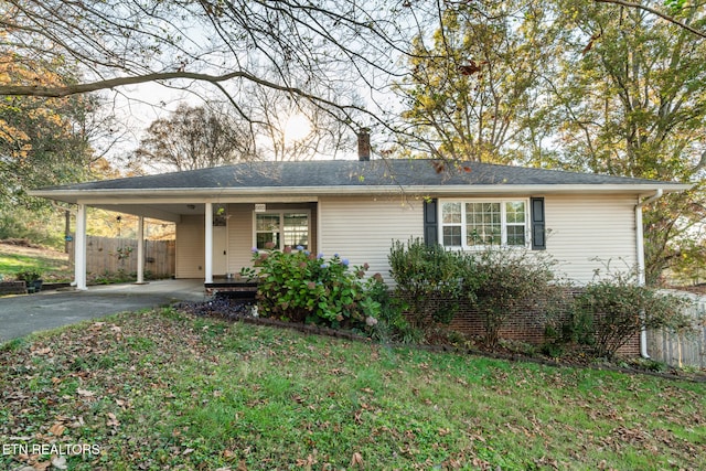 single story home with a carport and a front yard