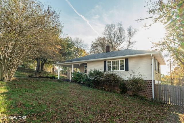 view of side of home with a yard