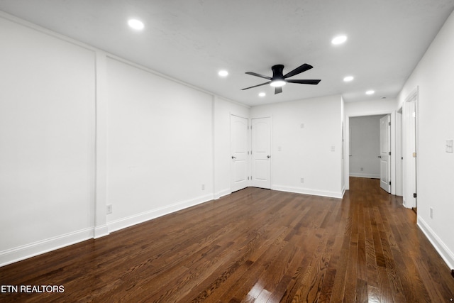 empty room featuring ceiling fan and dark hardwood / wood-style flooring