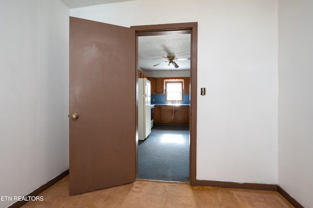 hallway featuring light carpet