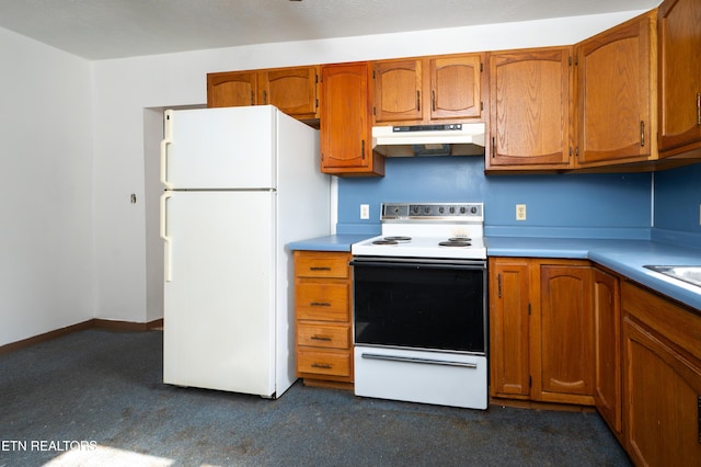 kitchen with dark colored carpet and white appliances