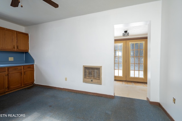 interior space featuring light carpet, french doors, and heating unit