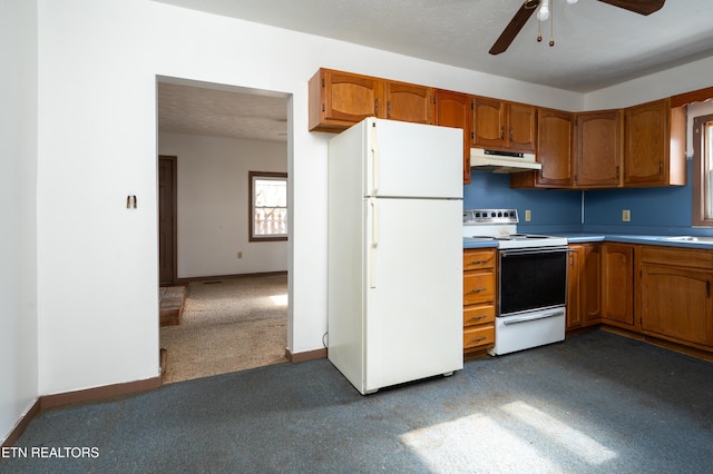 kitchen with a textured ceiling, ceiling fan, dark carpet, and white appliances