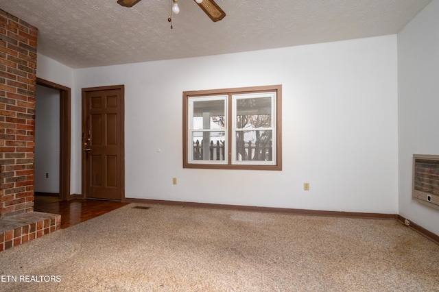 unfurnished living room with carpet, a textured ceiling, heating unit, and ceiling fan