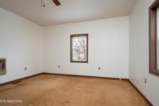 carpeted spare room with ceiling fan