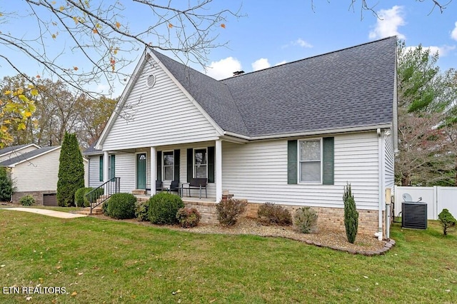 view of front facade featuring covered porch, a front lawn, and central air condition unit