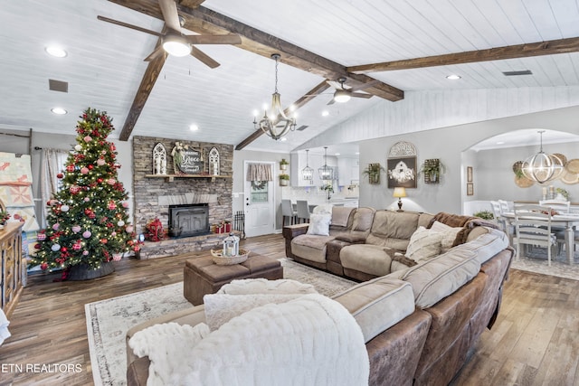 living room featuring vaulted ceiling with beams, hardwood / wood-style floors, and ceiling fan with notable chandelier