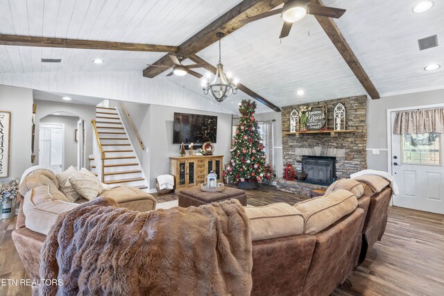 living room with ceiling fan with notable chandelier, wooden ceiling, a fireplace, hardwood / wood-style floors, and vaulted ceiling with beams