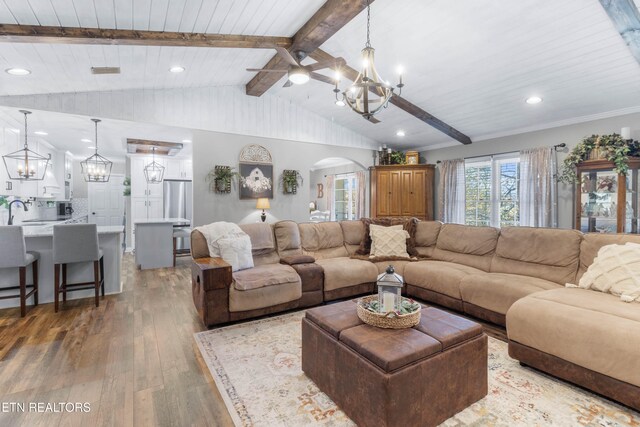 living room with vaulted ceiling with beams, hardwood / wood-style flooring, wooden ceiling, and sink