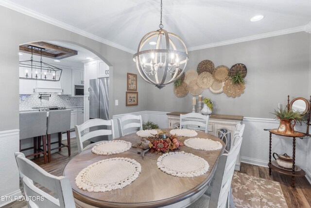 dining area featuring a chandelier, dark hardwood / wood-style flooring, and ornamental molding