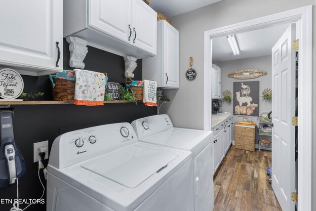 laundry room with cabinets, separate washer and dryer, and dark hardwood / wood-style floors