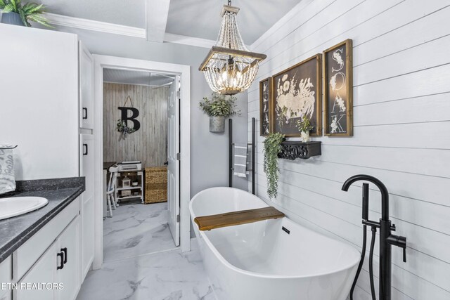 bathroom with vanity, ornamental molding, a tub to relax in, and wooden walls