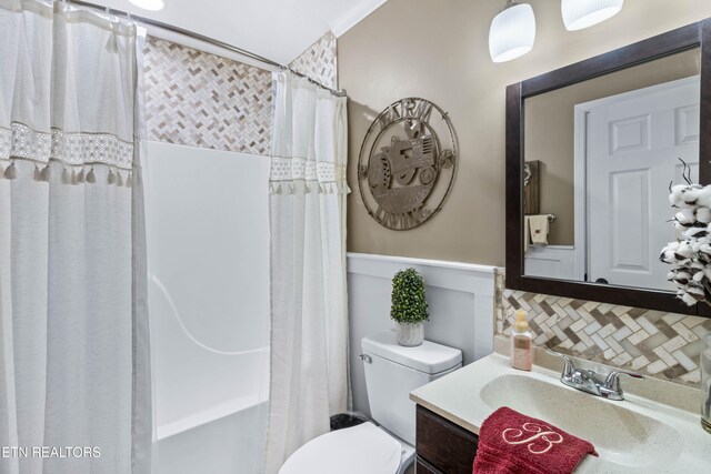 full bathroom with backsplash, shower / bath combination with curtain, toilet, vanity, and ornamental molding